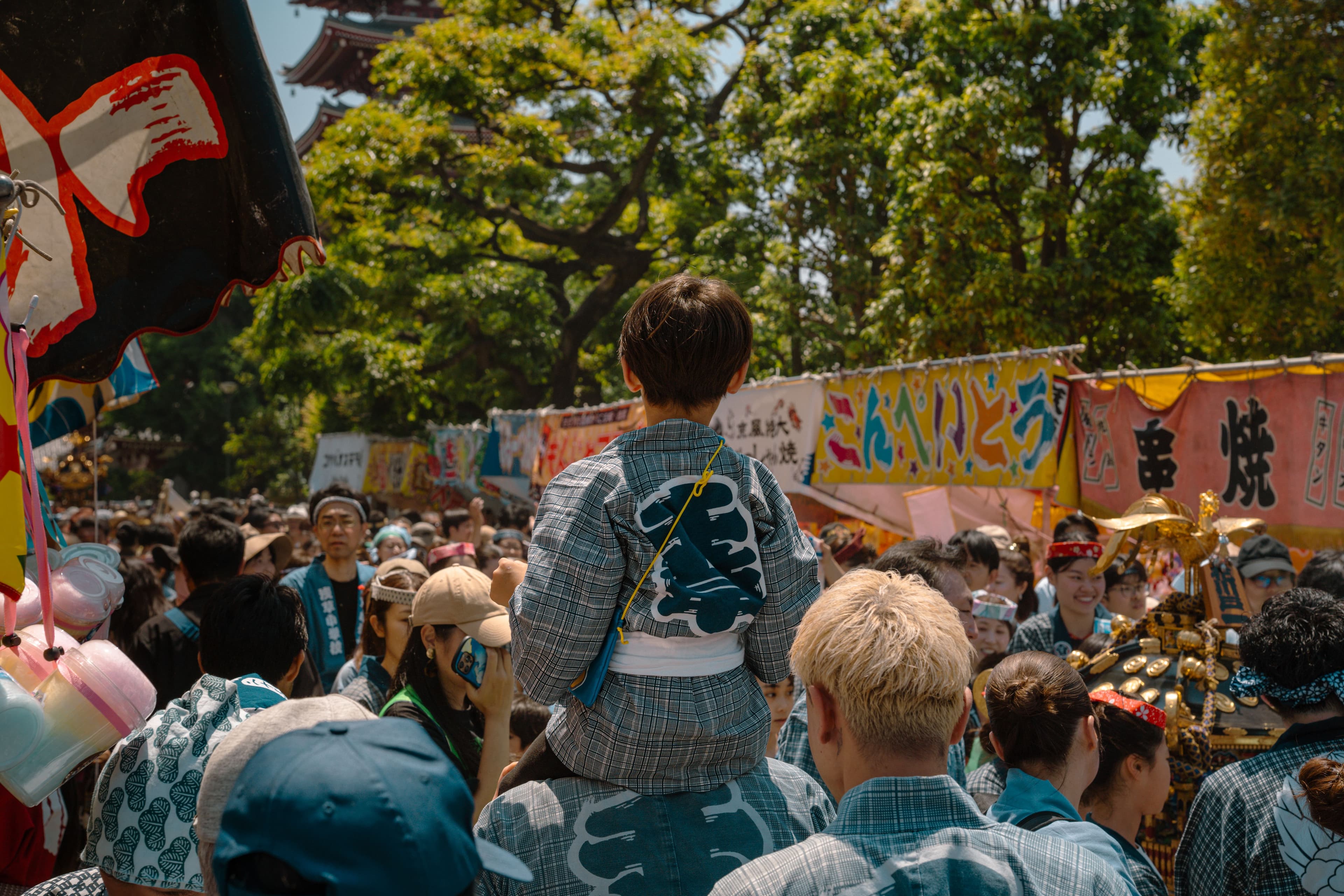 A child enjoying a Japanese festival with temple grounds in the background