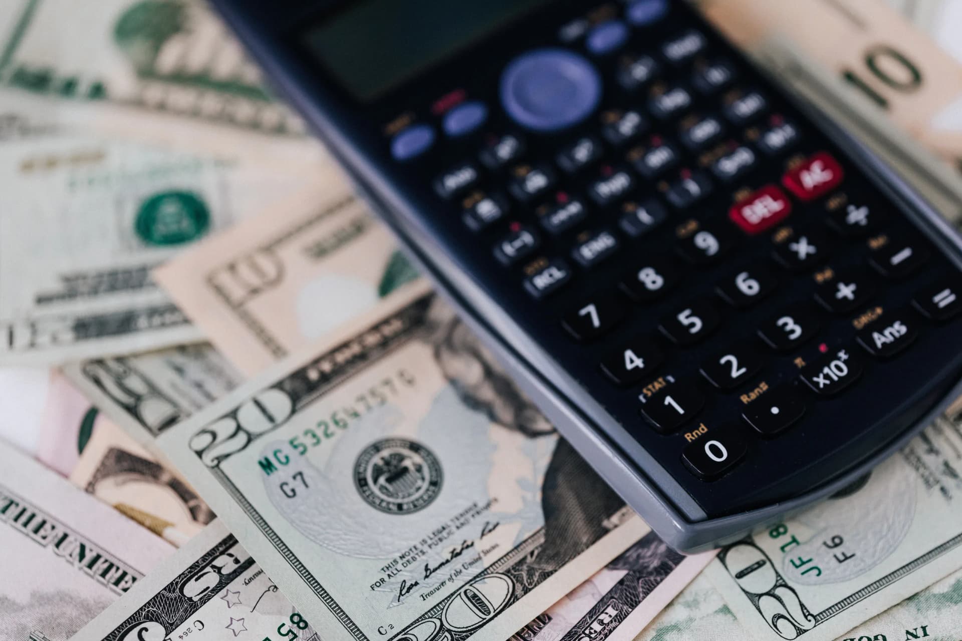 Calculator resting on travel money for a JR Pass cost comparison