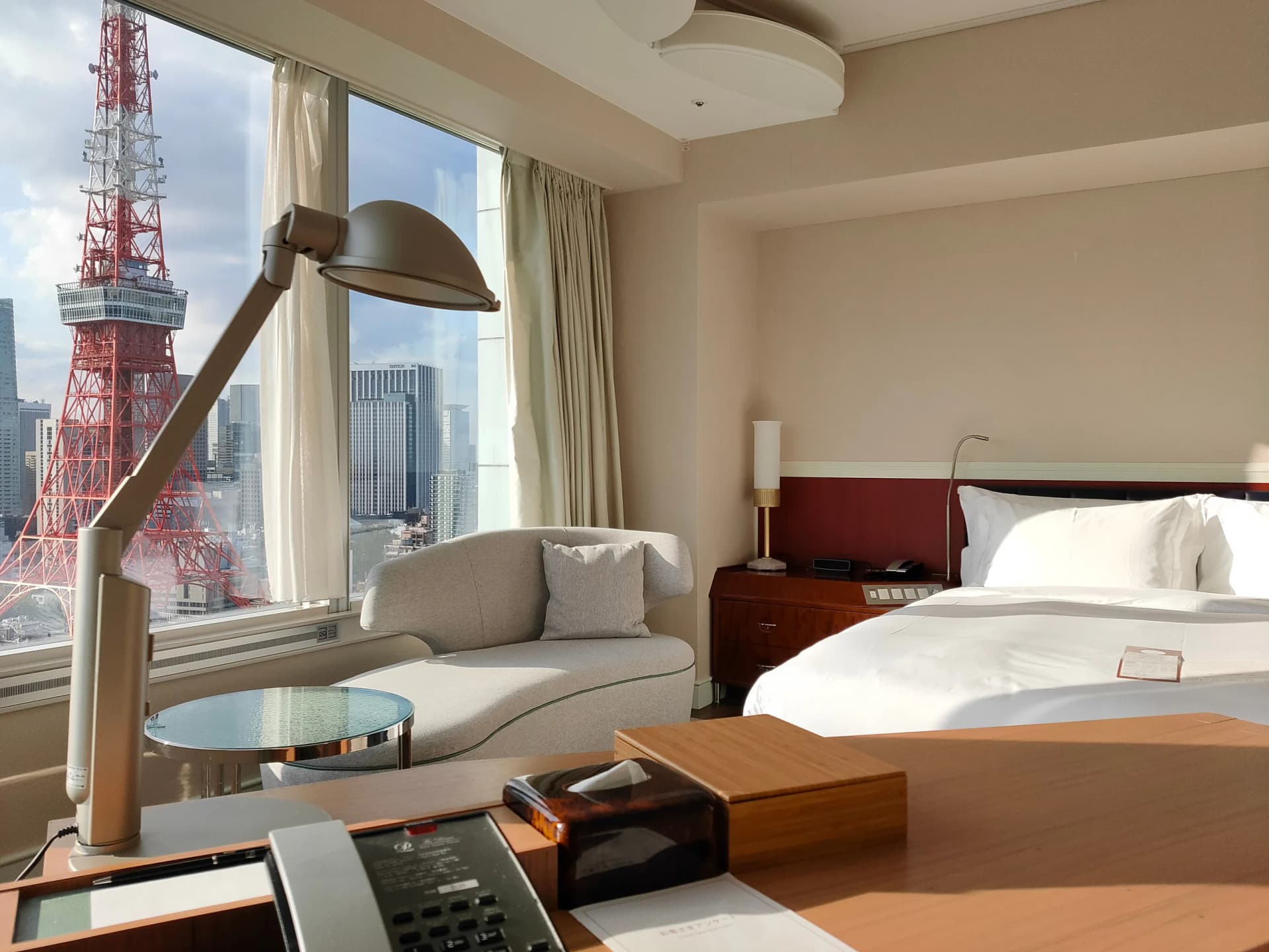 A bright Tokyo hotel room overlooking Tokyo Tower and the city skyline