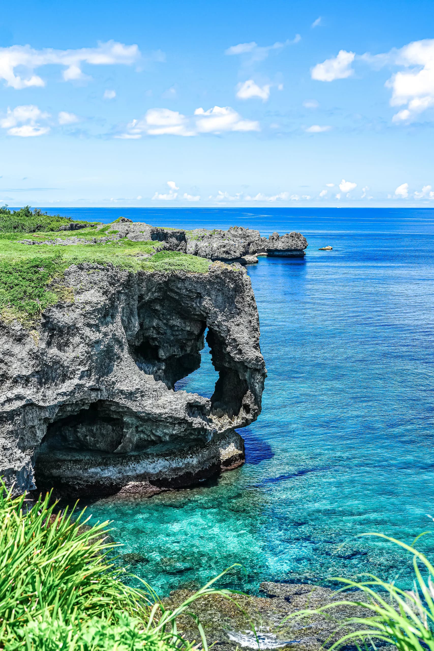 The elephant-trunk-shaped limestone cliff at Cape Manzamo above clear blue water